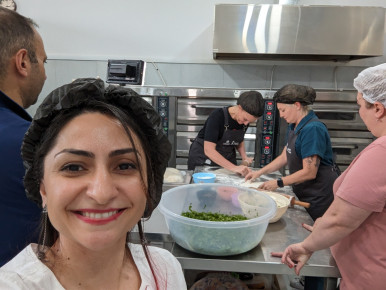 Chef Amanda Freitag baking Zhingyalov Hats and Gata with the NK displaced women at the Mets & More Bakery
