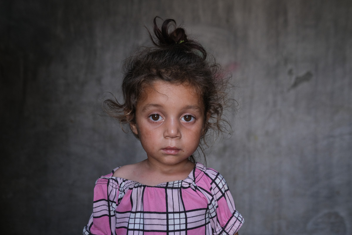 A 4-year-old Syrian girl posing to the camera in her home in northern Syria.