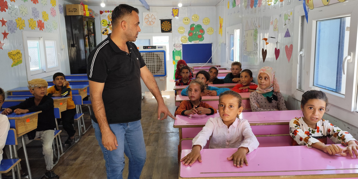 Hamood, in his class in one of the Temporary Learning Centres we support