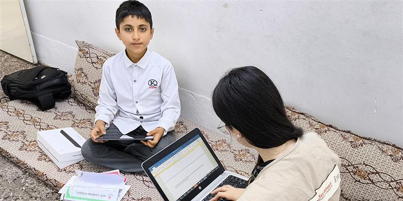 Eisa is in his room in Erbil Iraq, with PIN's staff playing PIN's environmental game after receiving the tablet